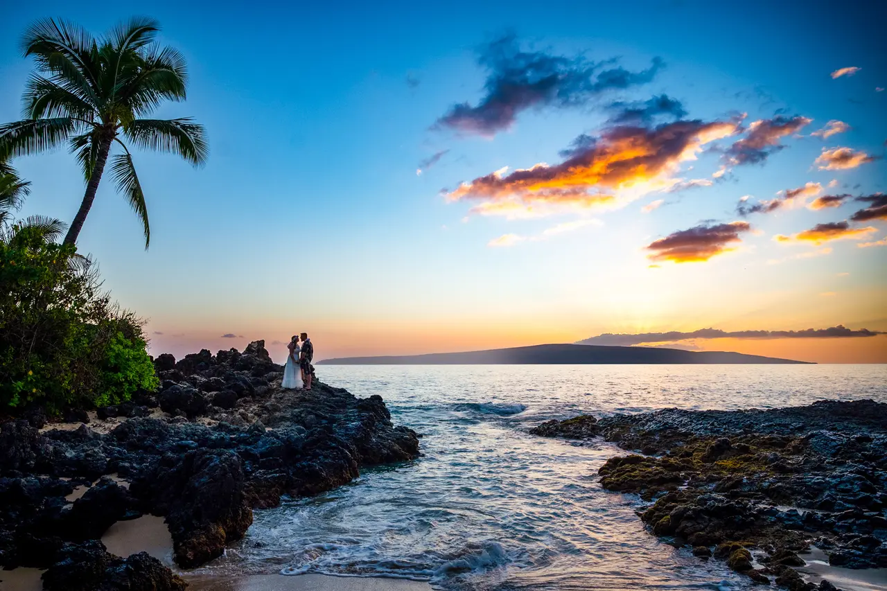 Makena Cove or Secret Cove, Maui, bride and groom silhouetted at sunset.